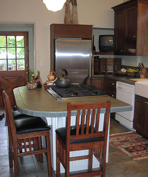 remodeled kitchen with cooktop and eating area on island